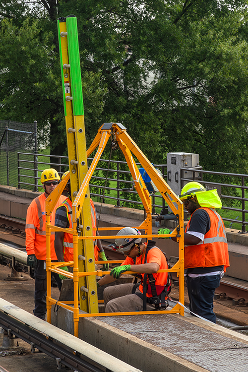 Metro workers install new switch box machines to prevent unwanted customer delays.